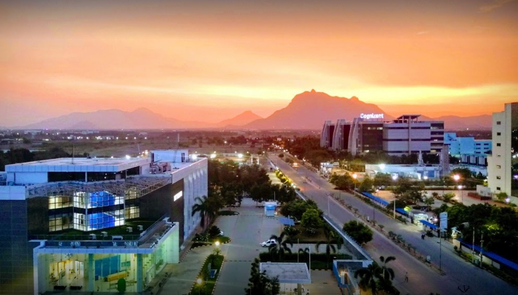 Coimbatore cityscape with modern buildings and distant mountains