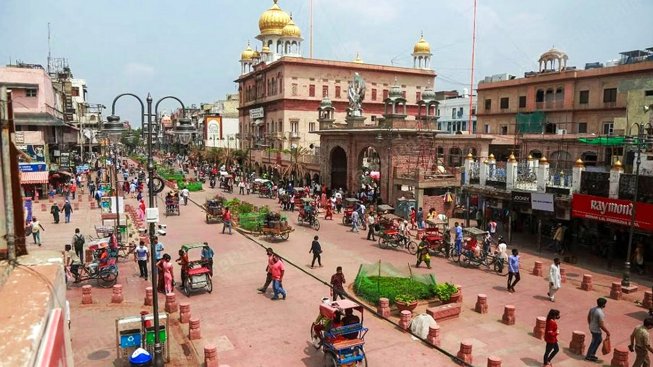 Narrow market lane in Chandni Chowk with shops and signage