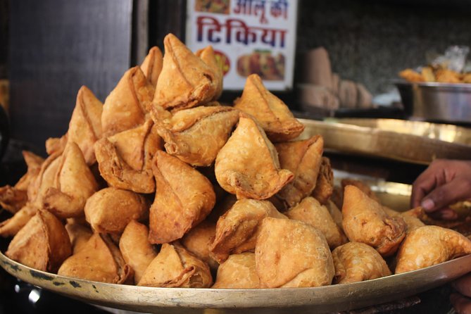 Street food counter in Old Delhi with local snacks and crowd