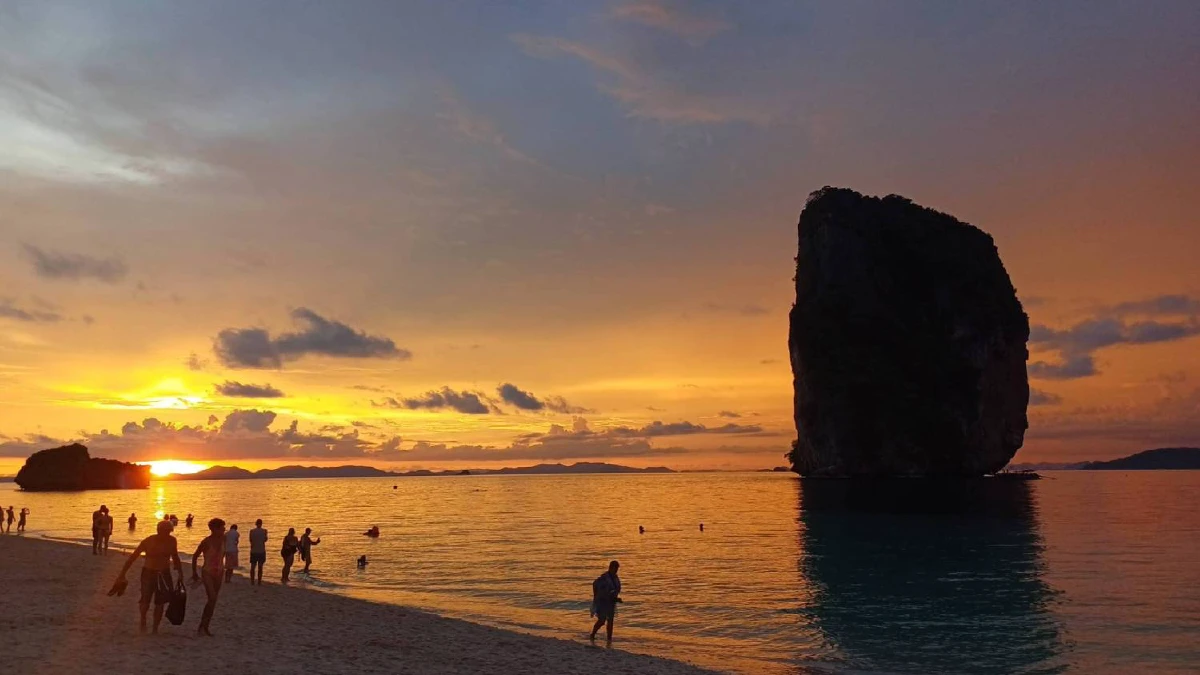 Sunset view over Poda Island with orange sky reflecting on turquoise water