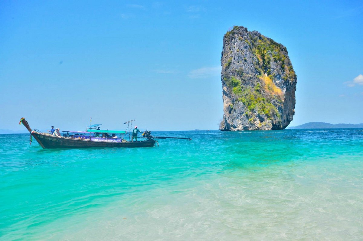 Snorkeler exploring coral reefs around Poda Island Thailand