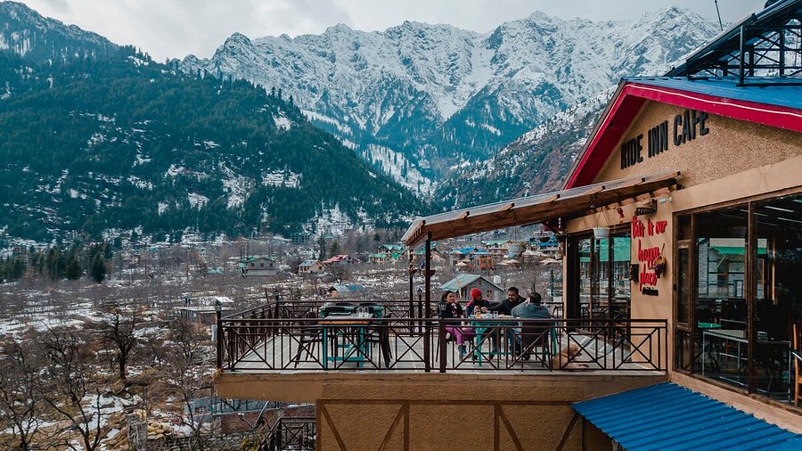 Cozy cafe in Manali with mountain views and warm lighting