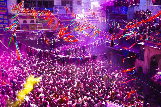 Holi celebrations at Pushkar Lake with devotees playing with colors