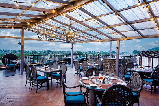 Rooftop restaurant in Srinagar with panoramic views of mountains and Dal Lake