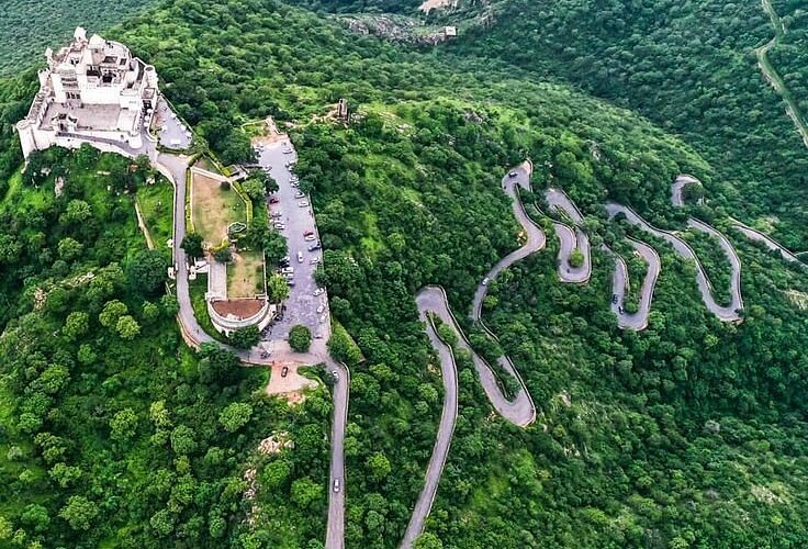 Sajjangarh Fort Udaipur on hilltop with panoramic city and lake views