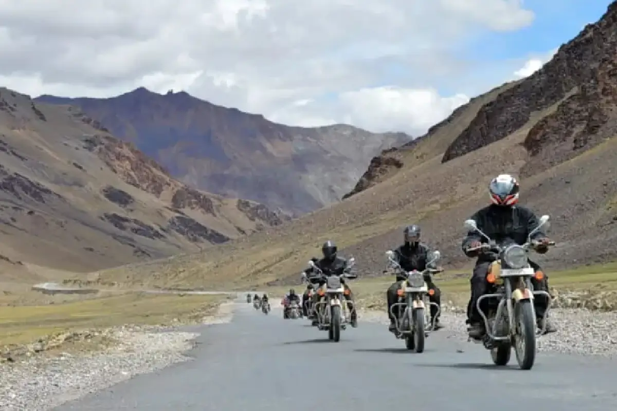 Motorcyclist riding through Spiti Valley mountains