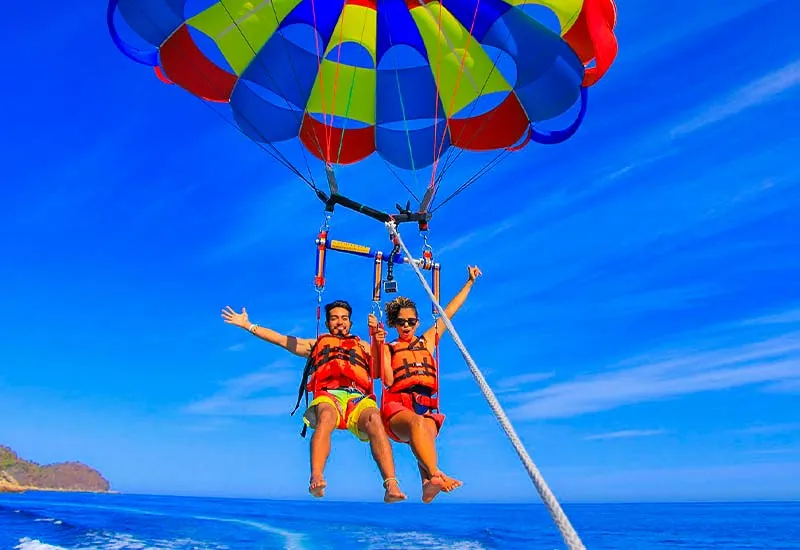 Water sports setup with jet skis and parasailing boats at Sinquerim Beach
