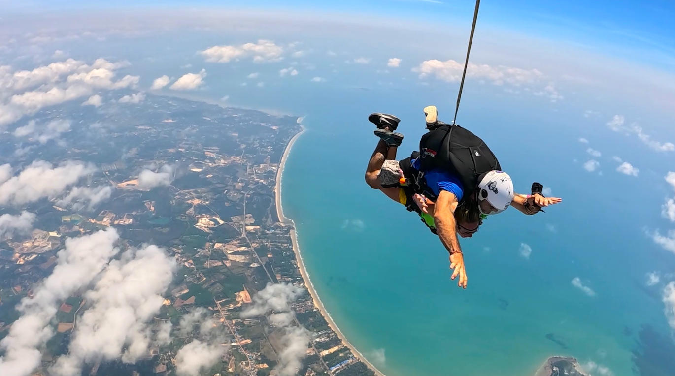 Skydiver at Pattaya dropzone with coastline view