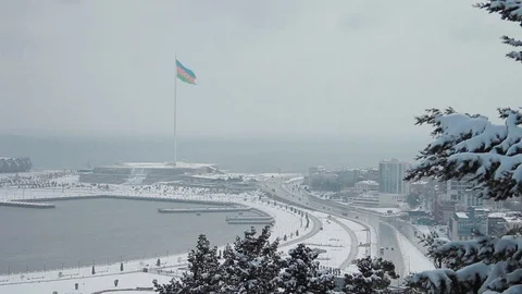 Baku Boulevard Caspian Sea promenade with snow-covered trees and walkways