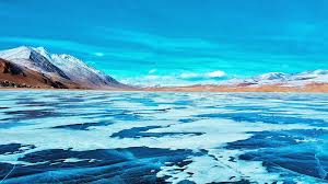 Frozen Pangong Lake in Ladakh during winter with snow-covered mountains