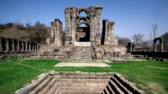 Martand Sun Temple ruins in Kashmir with mountain backdrop and open courtyard