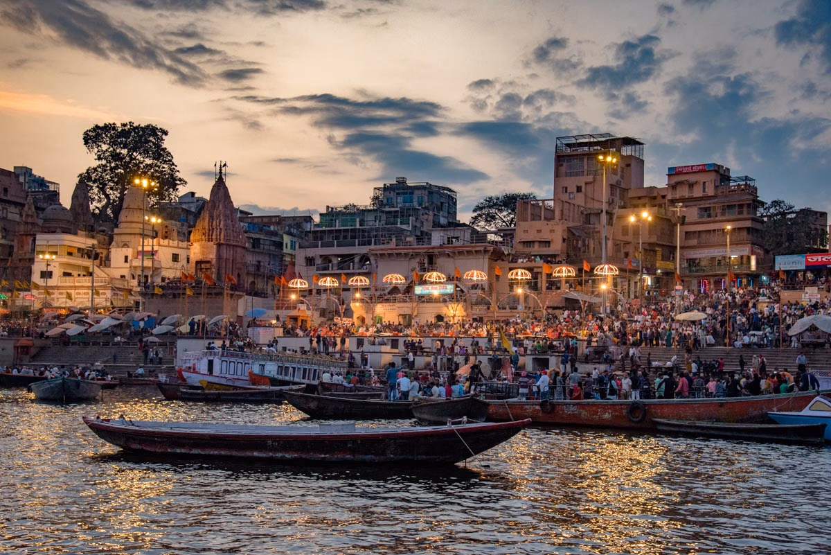Photographer capturing Varanasi sunrise from boat