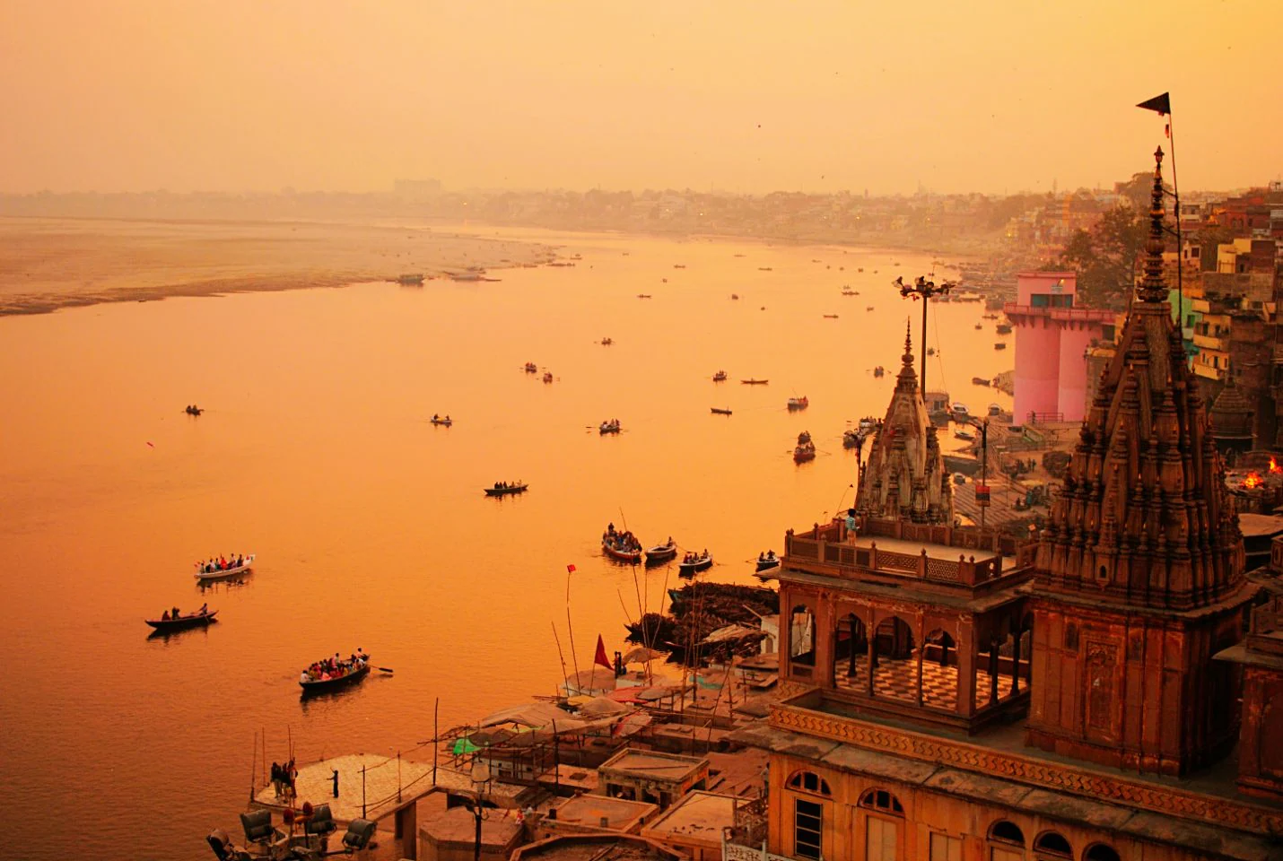 Sunset in Varanasi with glowing ghats and boats on the Ganga river
