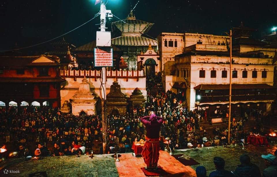 Evening aarti lights in a South Indian temple courtyard