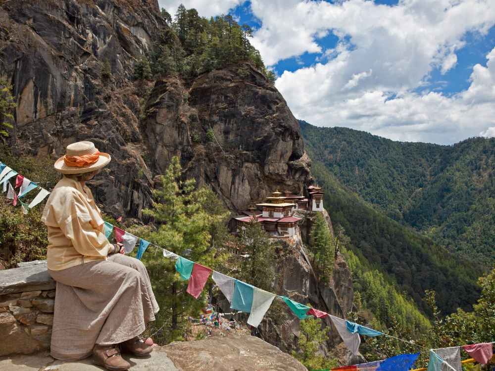 Final ascent stairs and prayer-flag area near Tiger Nest monastery entry