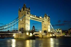 Tower Bridge illuminated at night with reflections on River Thames