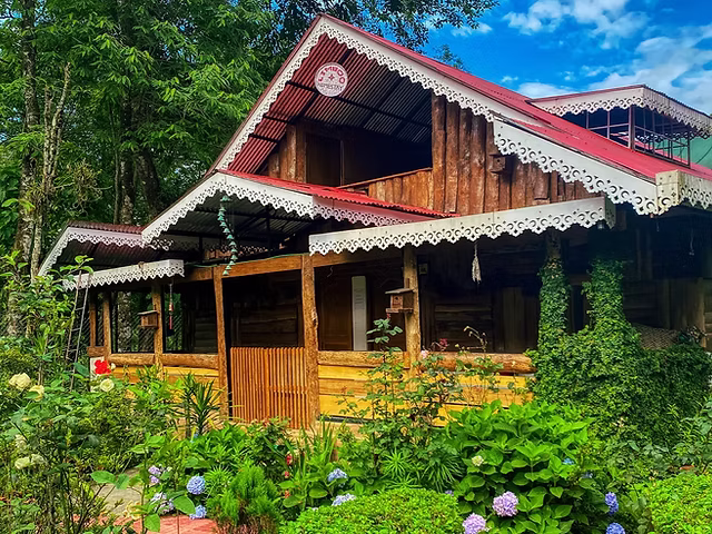 Traditional wooden homestay in Tulail Valley with mountain views