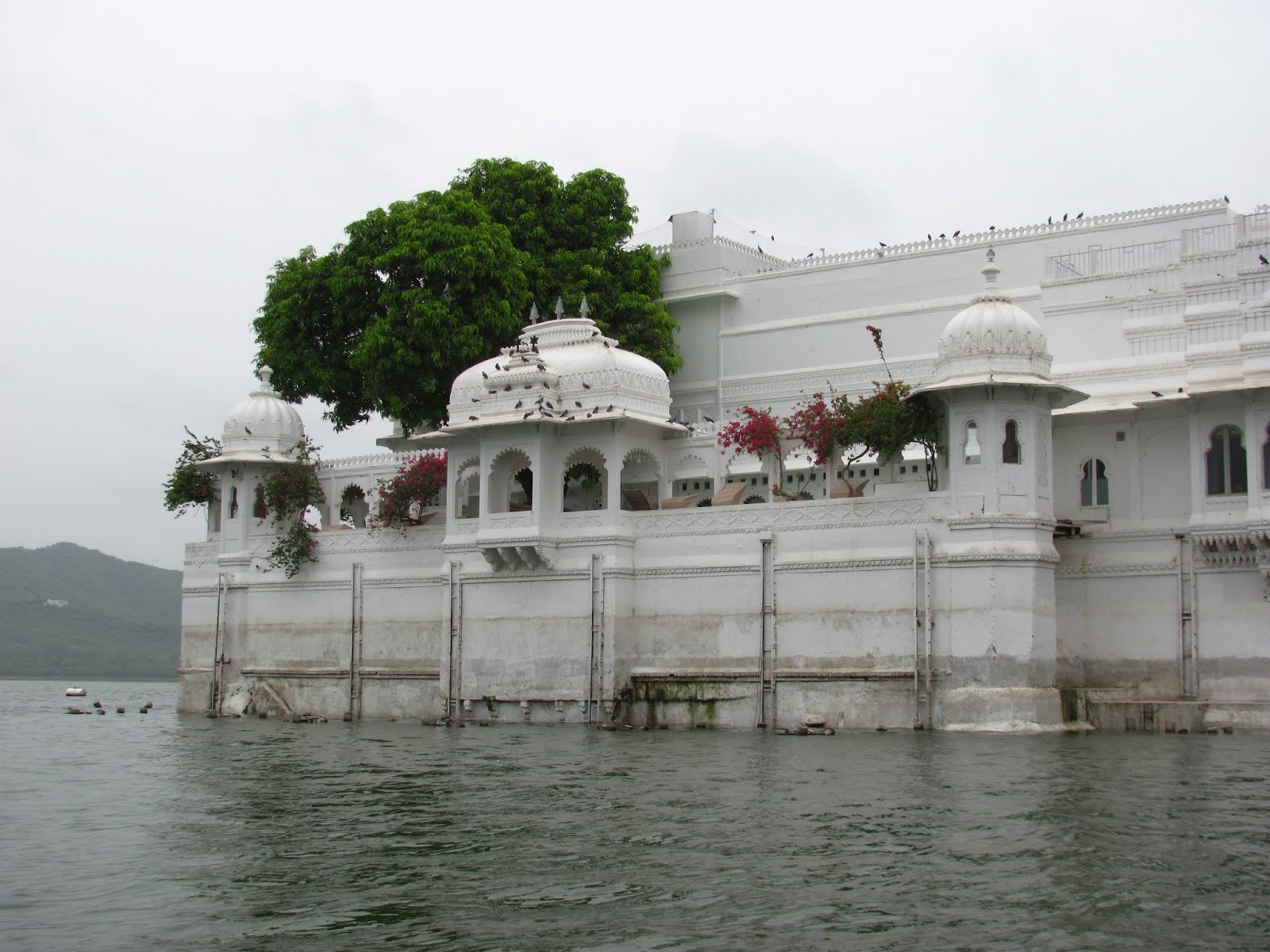 Lake Pichola waterfront view during monsoon rain in Udaipur