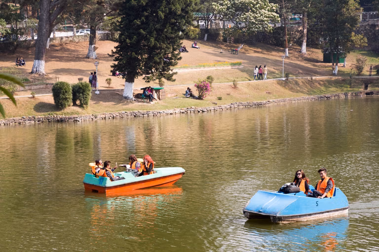 Colorful wooden boats on Ward's Lake with people enjoying boat rides