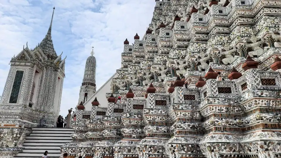 Intricate architectural details showing seashell and porcelain decorations on Wat Arun prang