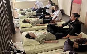 Thai massage therapy session in progress at Wat Pho