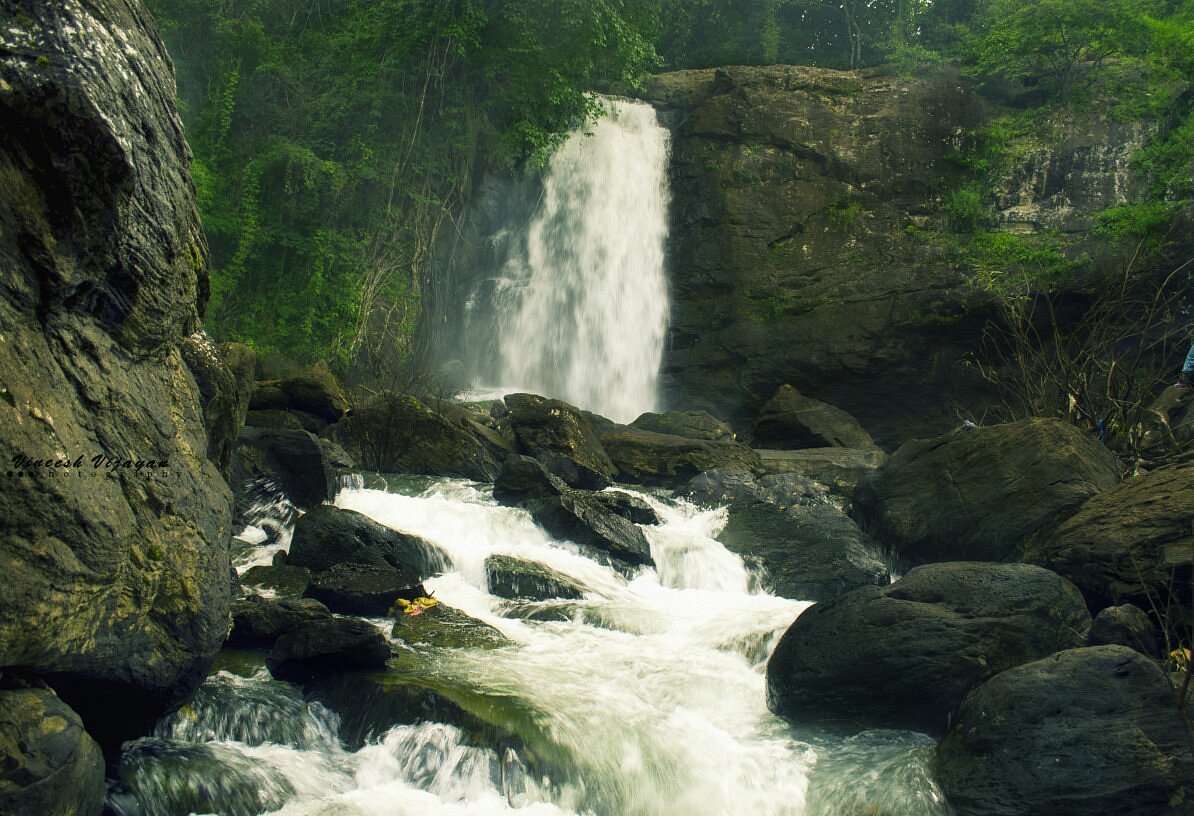 Soochipara Waterfalls in Wayanad with layered rock and forest backdrop
