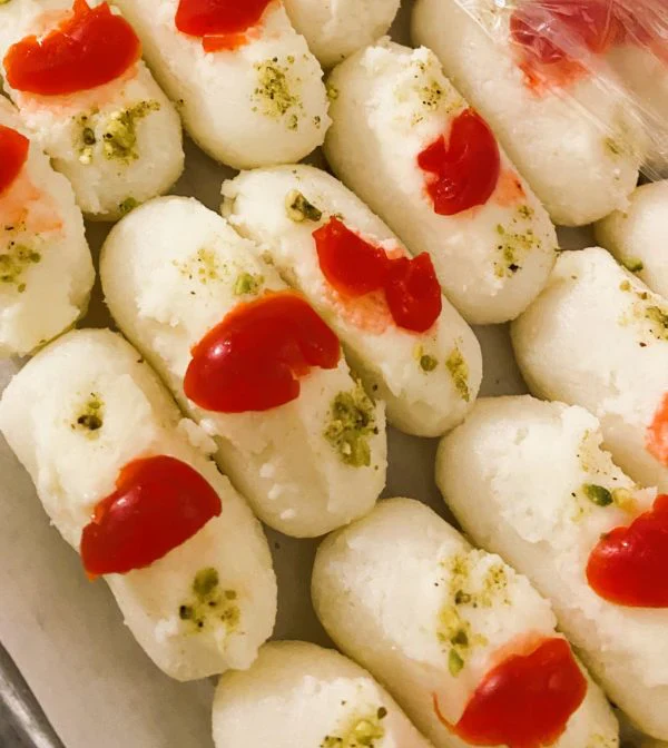 Assortment of Bengali sweets including rasgulla and sandesh